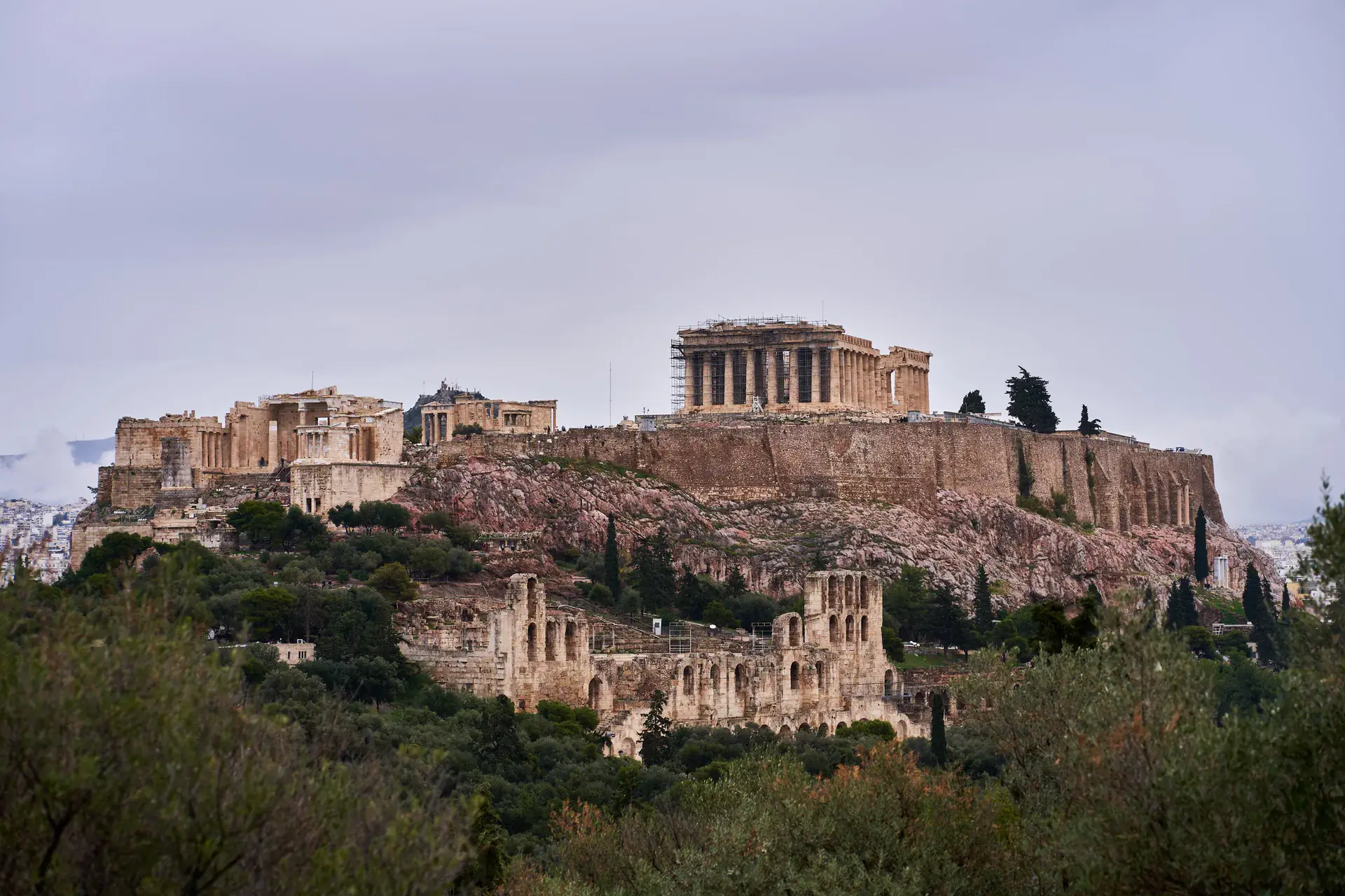 The Acropolis of Athens viewed from Philopappos Hill, showing the complete ancient complex with the Parthenon prominently centred against the Athens cityscape