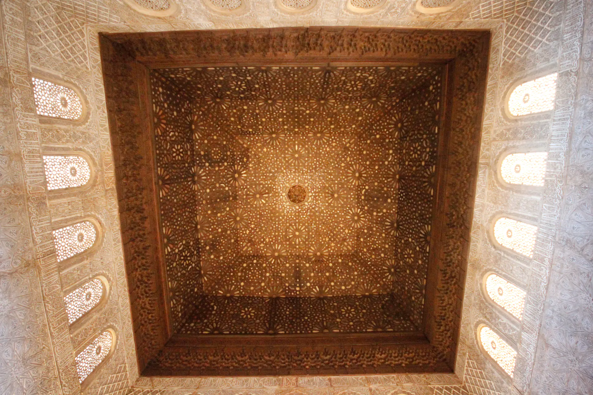 Spectacular muqarnas dome ceiling in Hall of Ambassadors with geometric star patterns at Alhambra