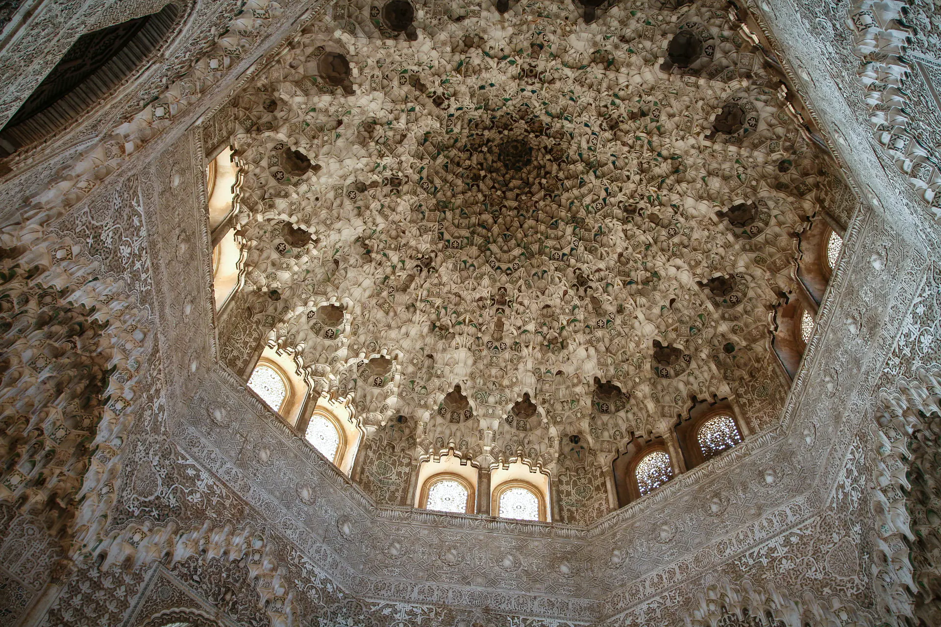 Intricate muqarnas dome ceiling with honeycomb stalactite structure at Alhambra palace
