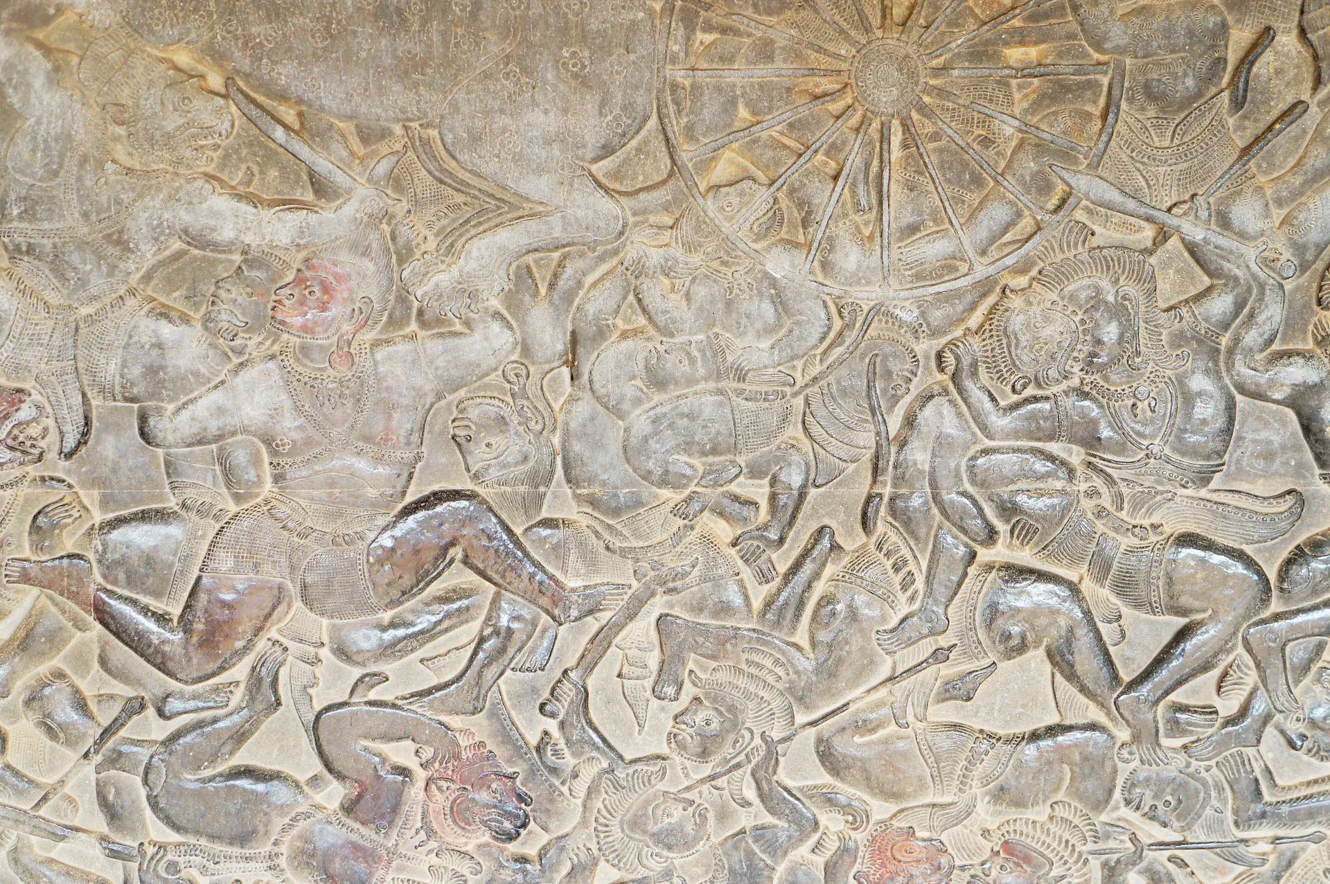 Intricate bas-relief carving at Angkor Wat showing the mythological battle between devas and asuras during the Churning of the Ocean of Milk