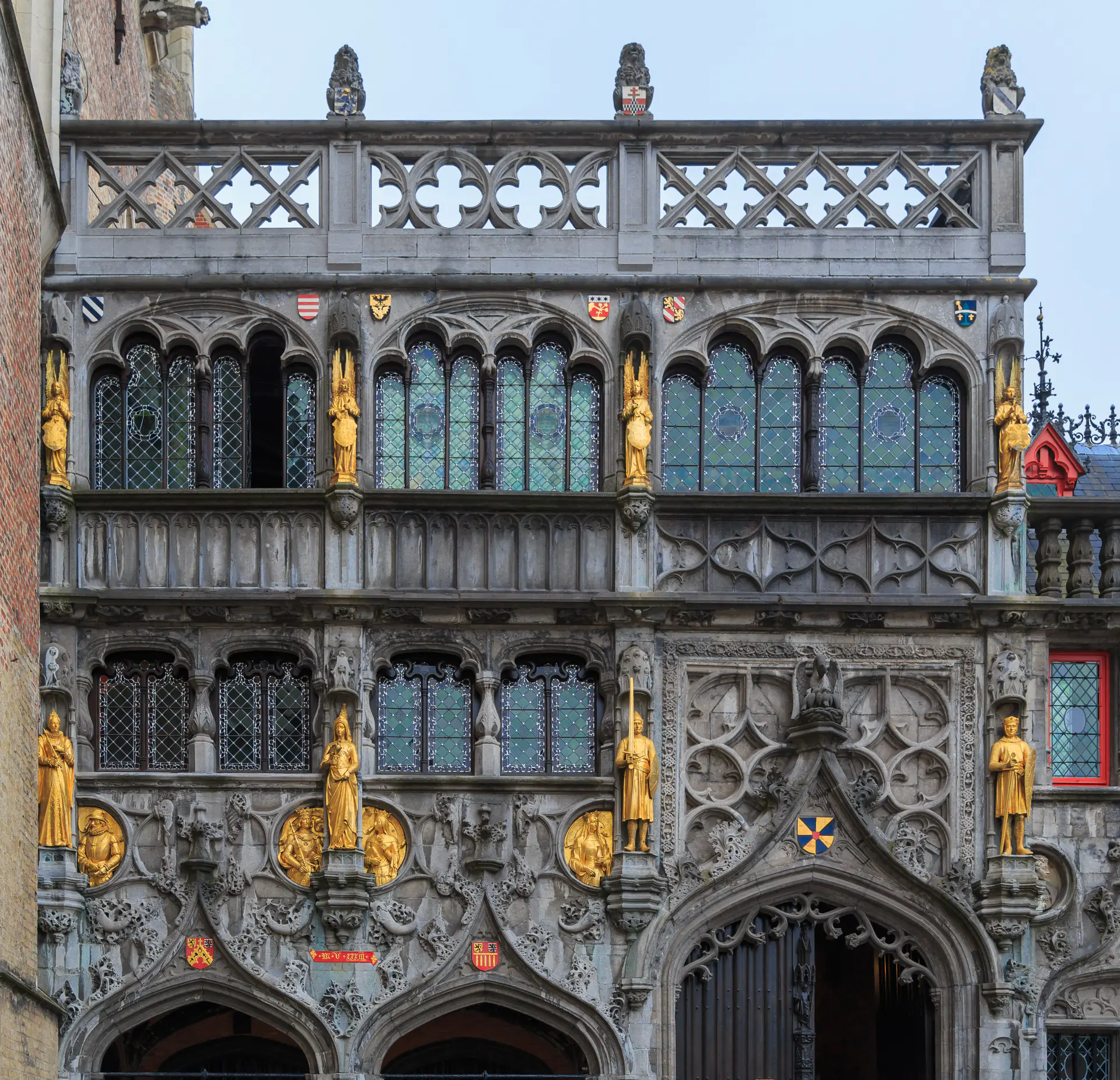 Ornate neo-Gothic facade of the Basilica of the Holy Blood on Burg Square with decorative stonework and religious architectural details