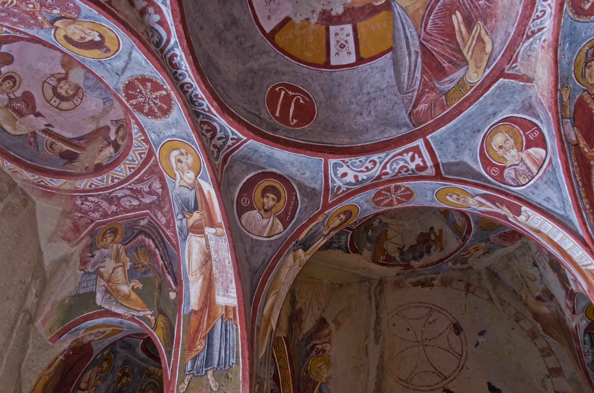 Vibrant Byzantine frescoes depicting biblical scenes on the walls and ceiling of Elmali Church in Göreme