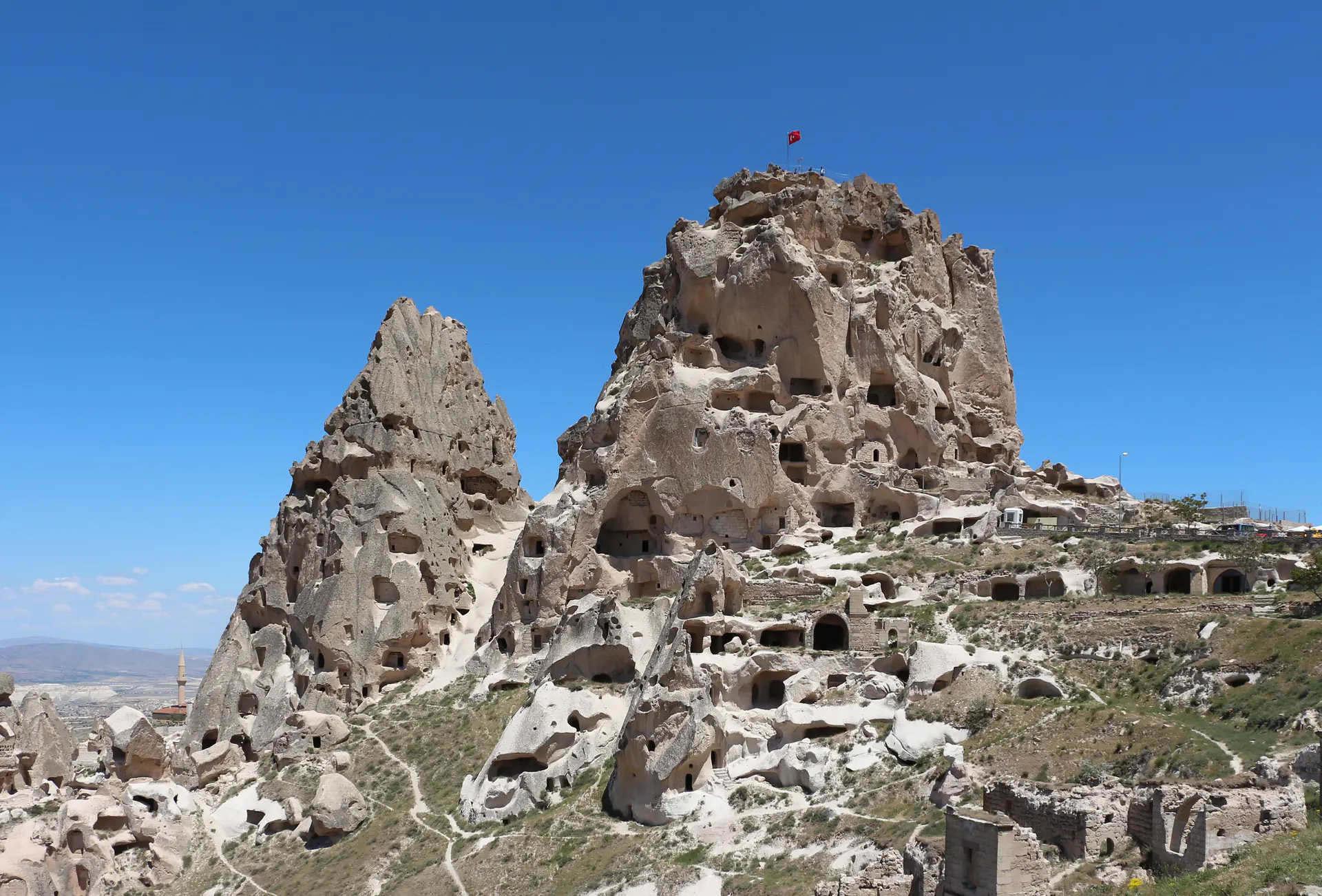 Uçhisar Castle rock fortress honeycombed with cave dwellings rising above Cappadocia landscape