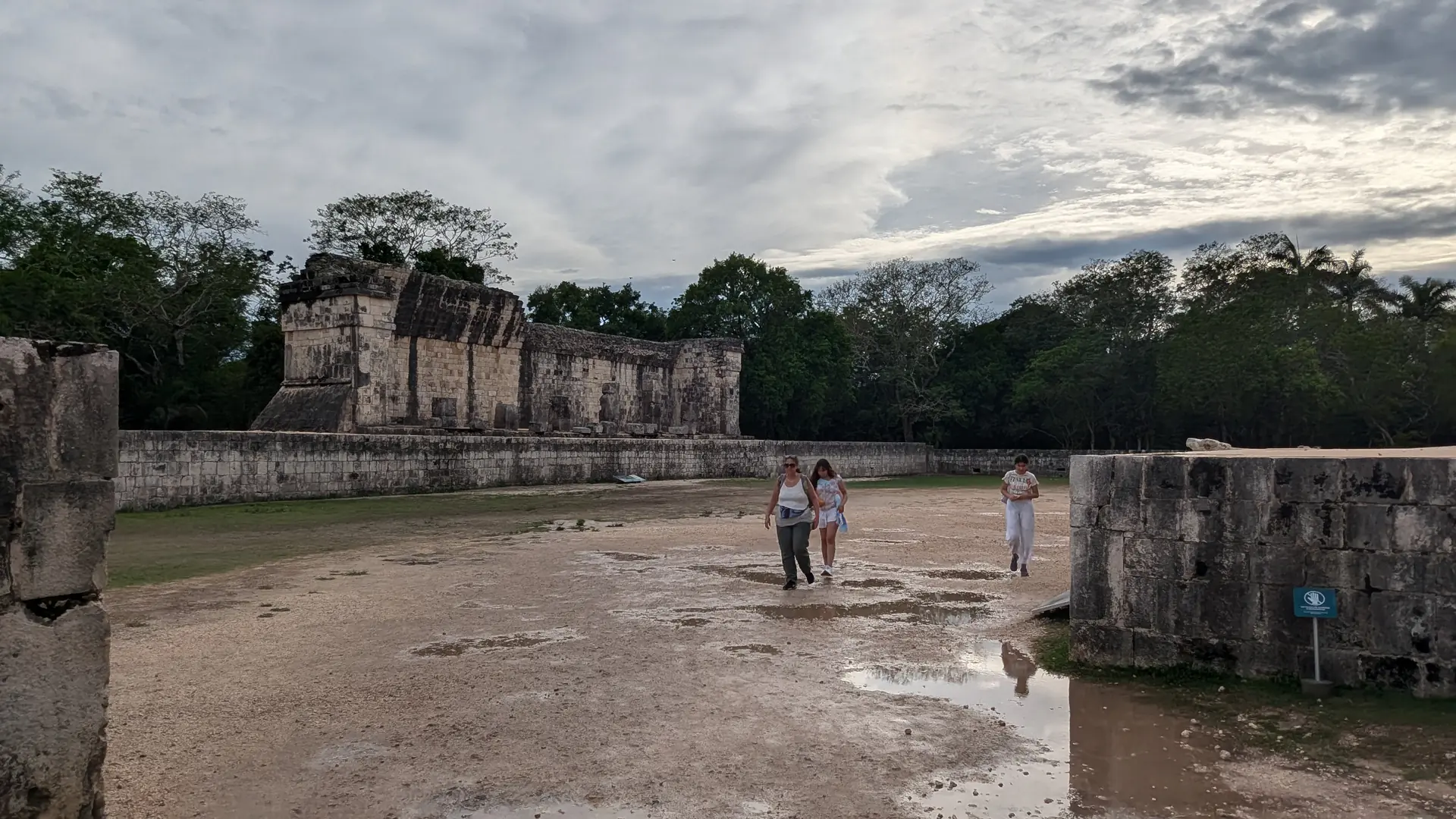 The massive Great Ball Court showing towering stone walls and playing field at Chichen Itza archaeological site