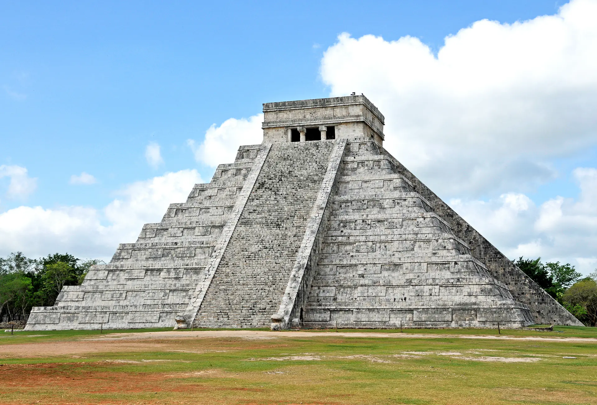 El Castillo pyramid viewed from the north side showing the full stepped structure rising above the archaeological plaza