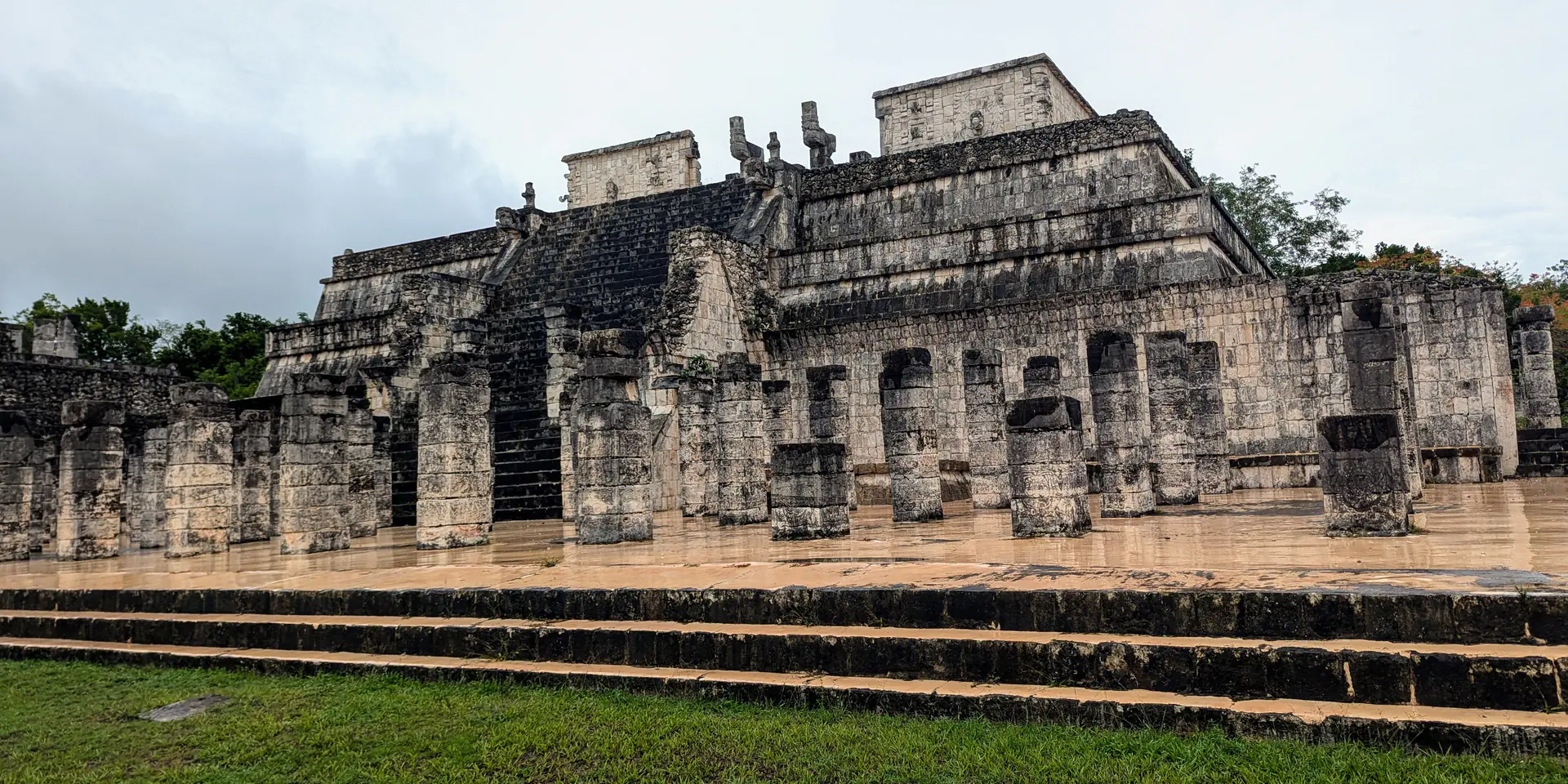 Temple of Warriors pyramid with carved columns and ancient Maya architecture at Chichen Itza
