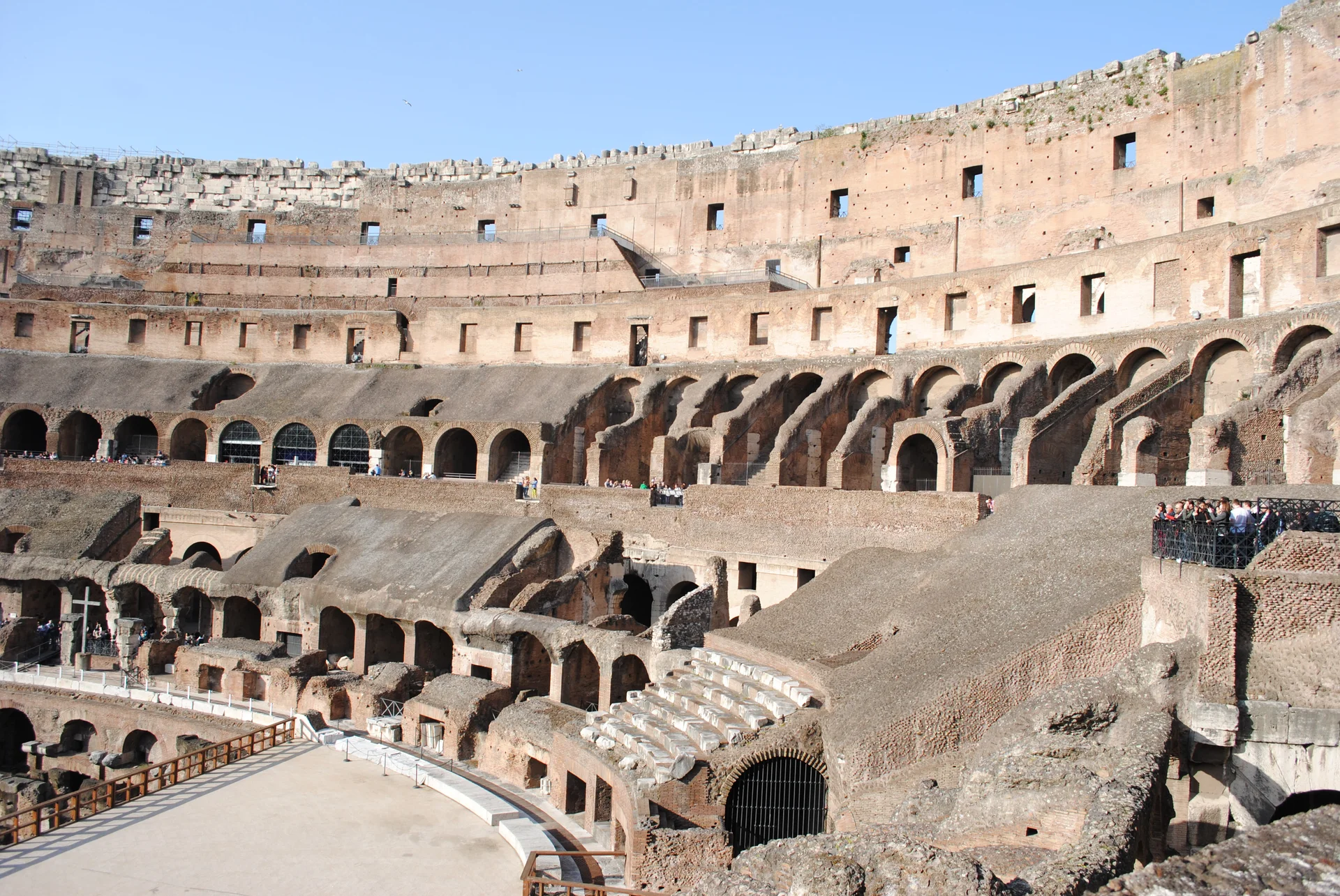 Interior view of the Colosseum showing the partially reconstructed arena floor with the exposed hypogeum underground chambers and tunnel systems visible beneath