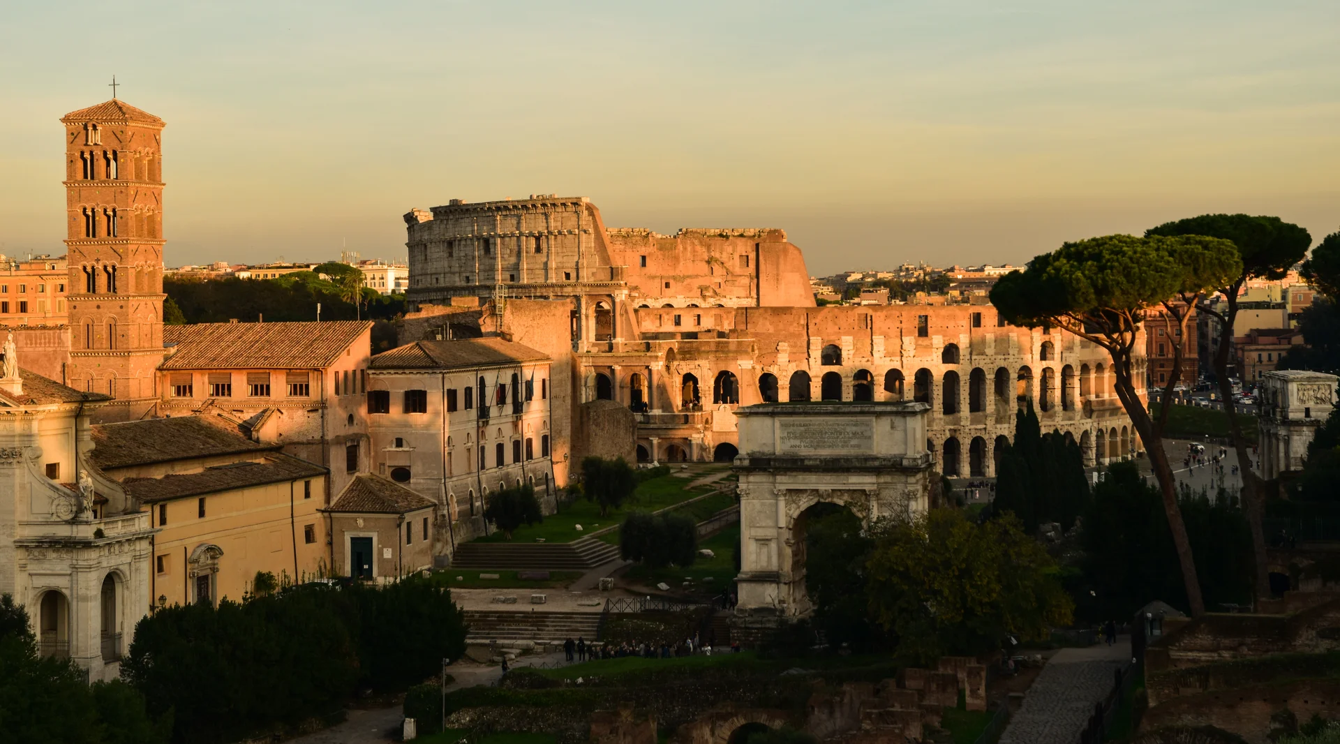 Panoramic view from the Colosseum's upper tier showing the ancient amphitheatre's impressive stone architecture with Rome's cityscape stretching into the distance