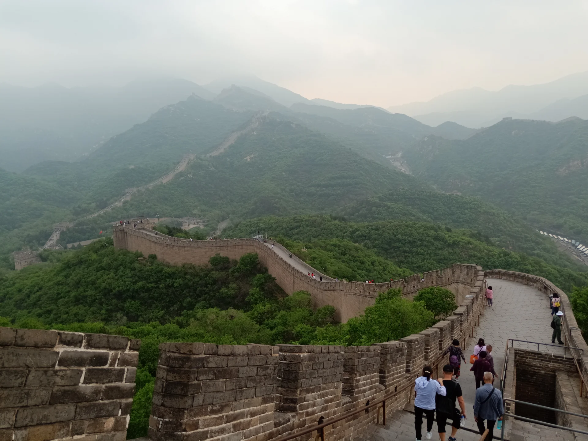 Panoramic view of the restored Badaling section of the Great Wall with multiple watchtowers visible winding across mountain ridges under clear skies