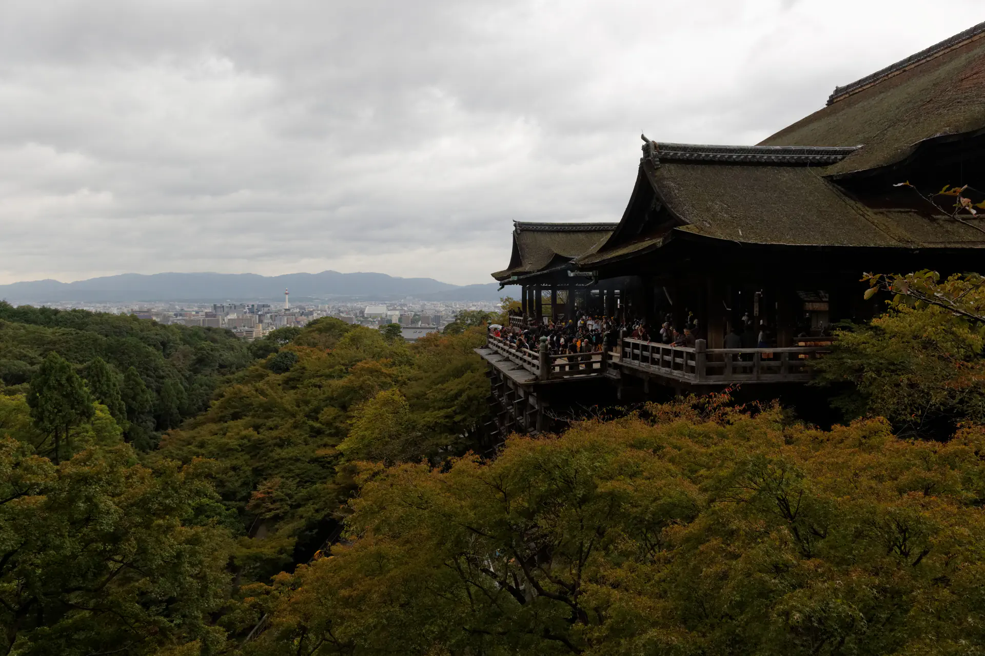 Kiyomizu-dera temple wooden veranda projecting from the hillside, supported by massive timber pillars demonstrating traditional Japanese carpentry without nails