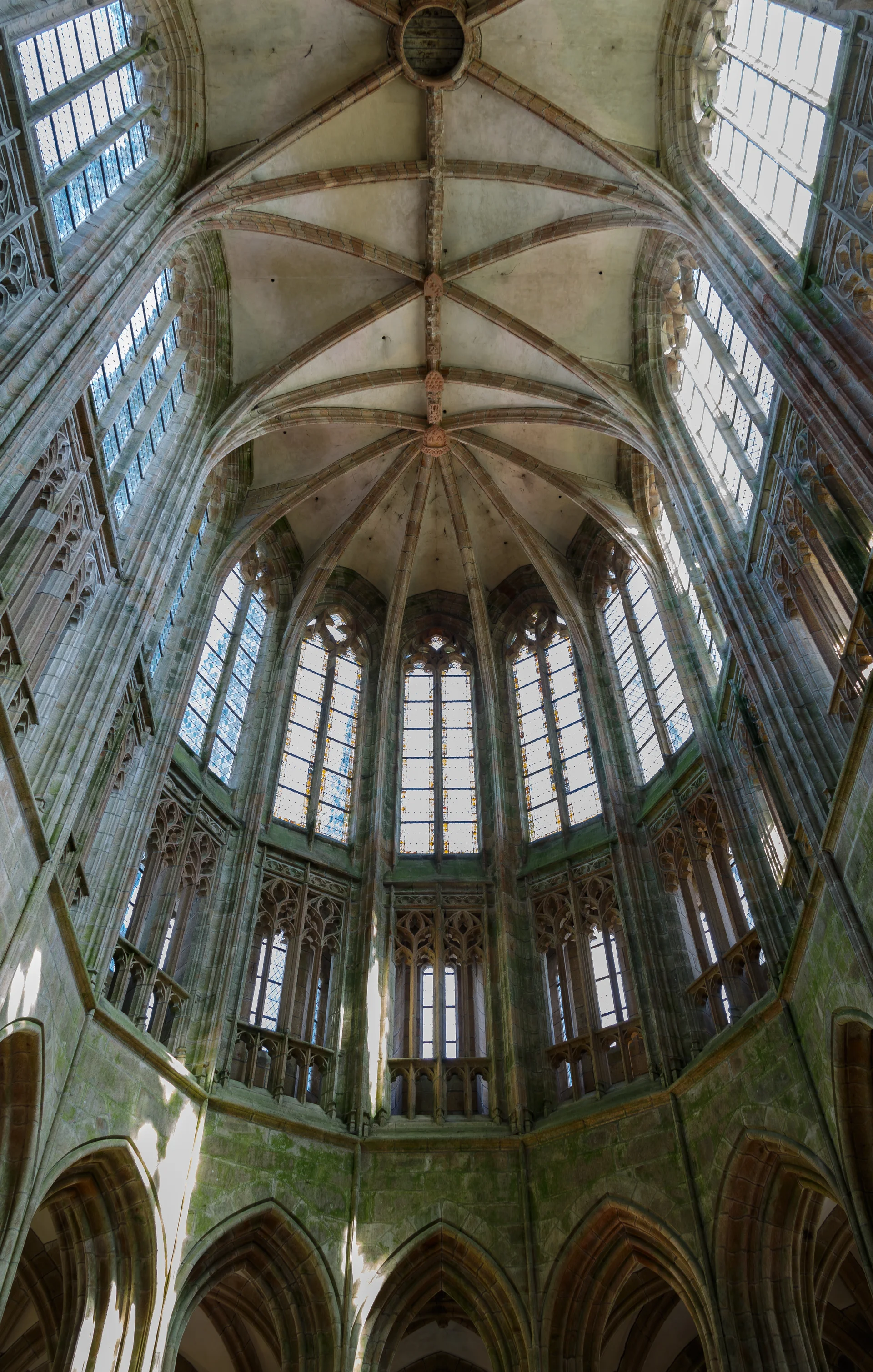 The soaring vaulted ceiling and Romanesque nave of Mont-Saint-Michel abbey church showing dramatic Gothic and Romanesque architectural elements