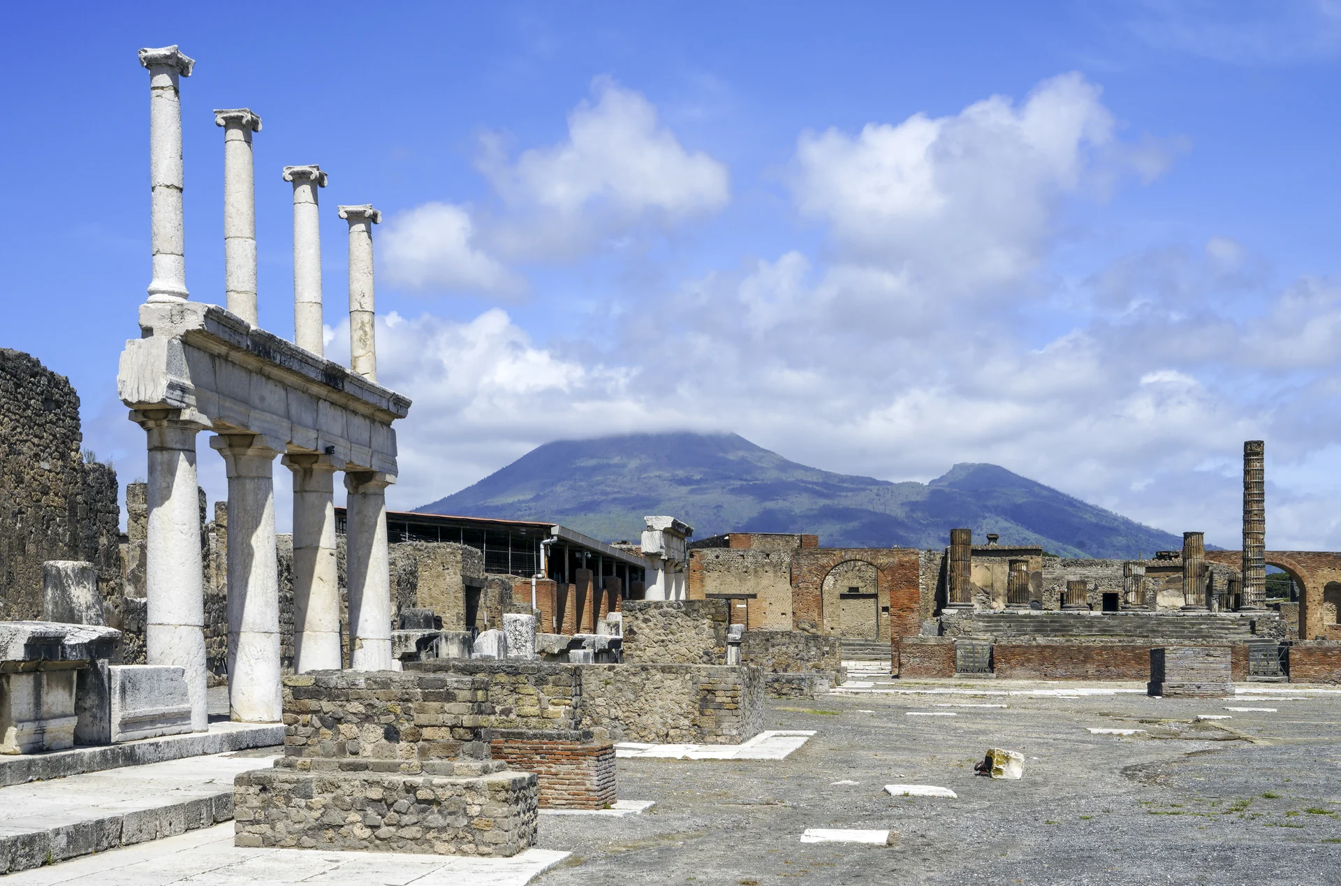 Panoramic view of the ancient Roman Forum of Pompeii with Mount Vesuvius visible in the background