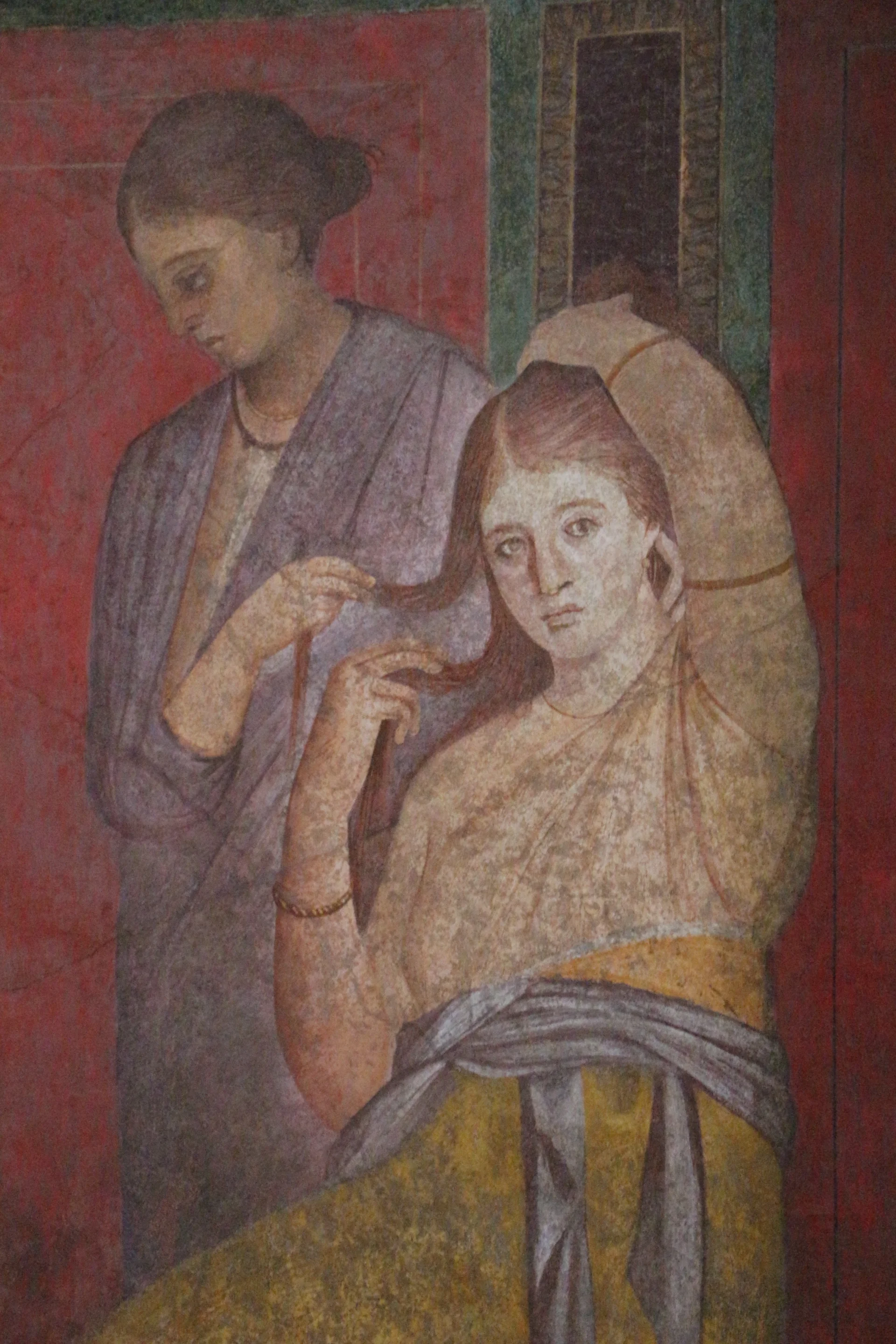 Interior view of the Villa of the Mysteries showing the famous mystery ritual frescoes on red background walls