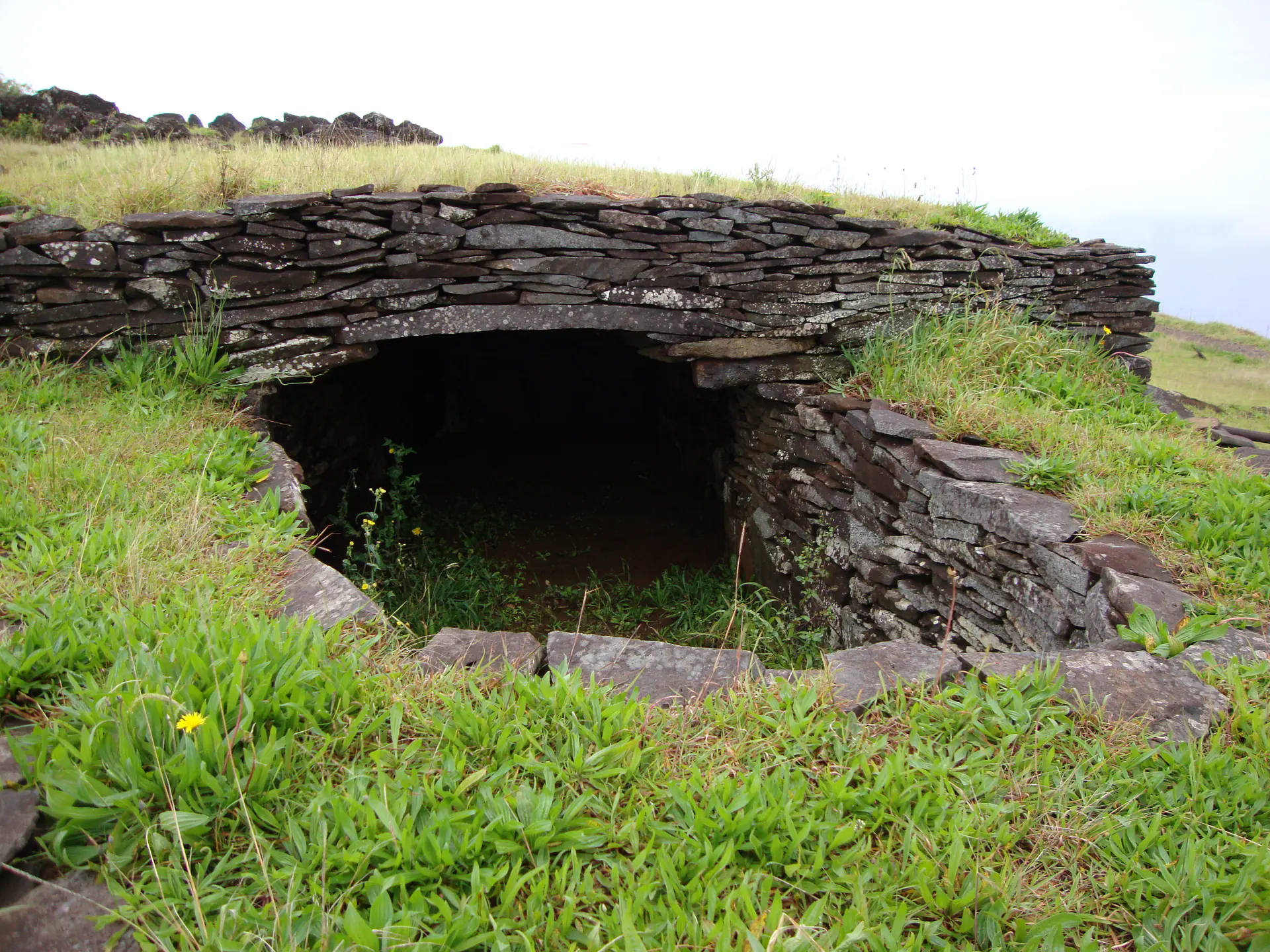 Partially reconstructed corbelled stone house at Orongo ceremonial village showing the distinctive building technique used by ancient Rapa Nui people