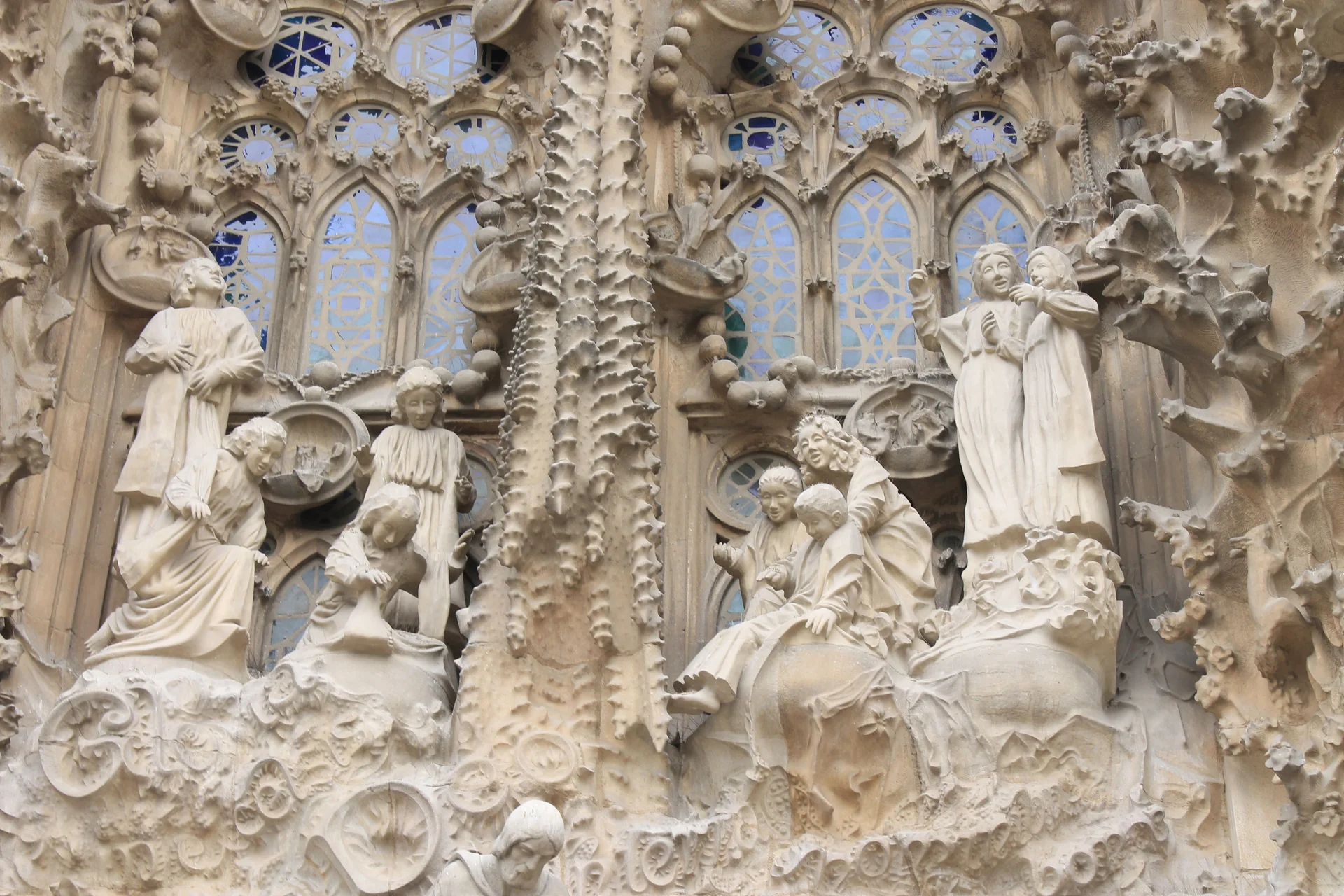Intricate stone carvings of the Nativity façade showing biblical scenes with organic, flowing design elements typical of Gaudí's architectural style